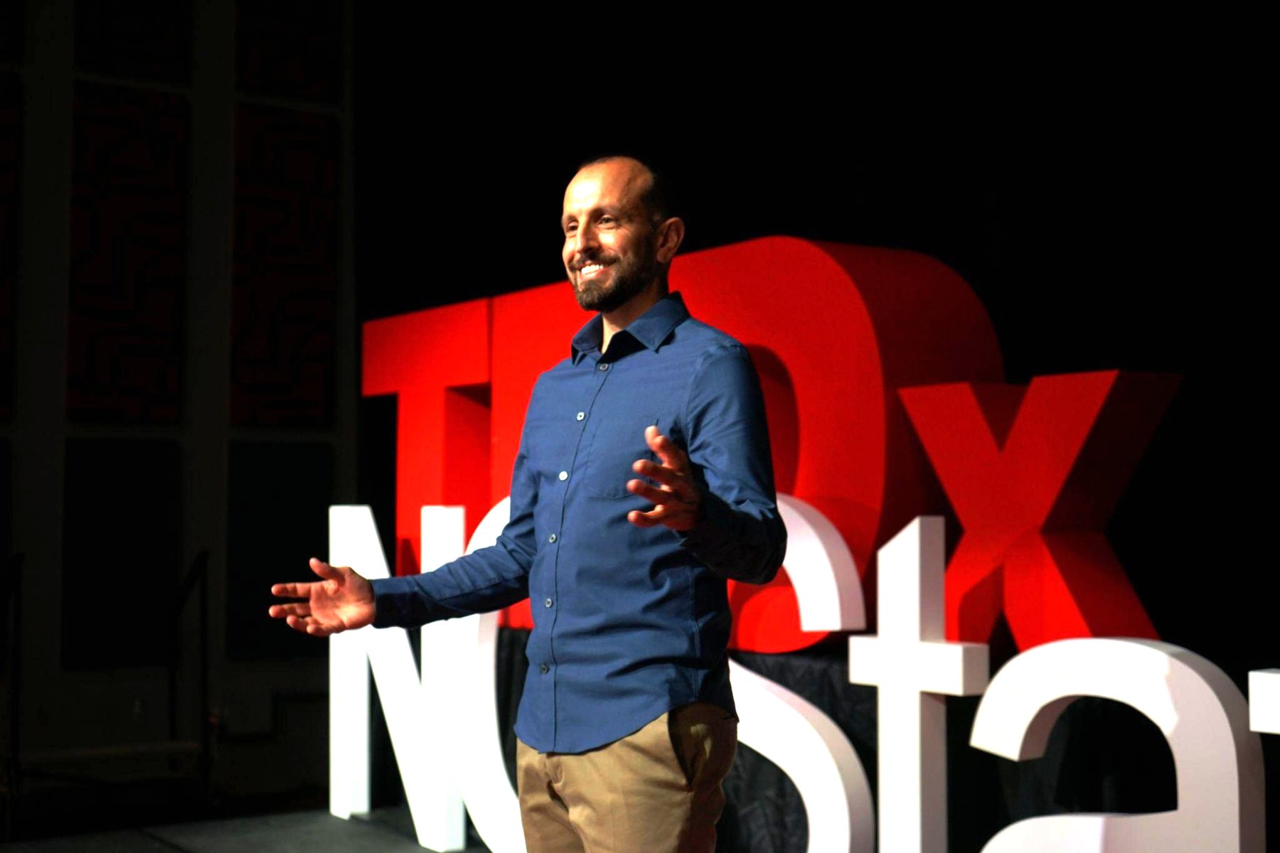 Mike Iskandar speaking on the TEDx stage